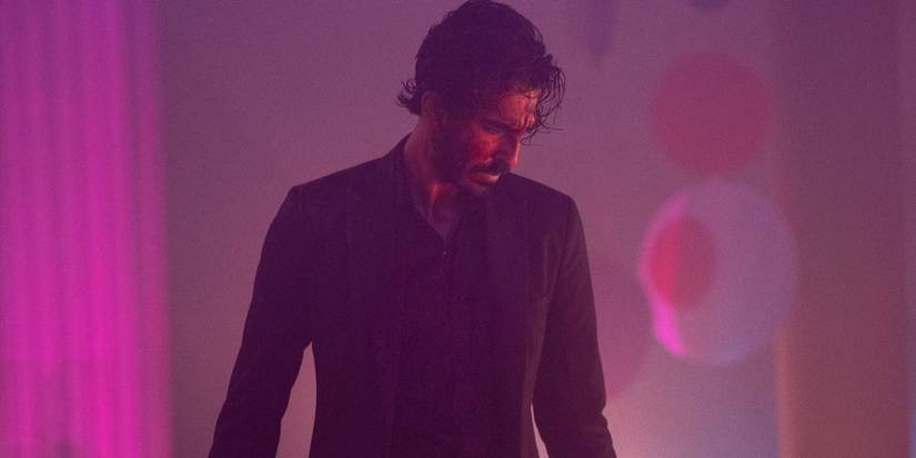 Dev Patel as Kid, in a neon-lit room in Monkey Man.