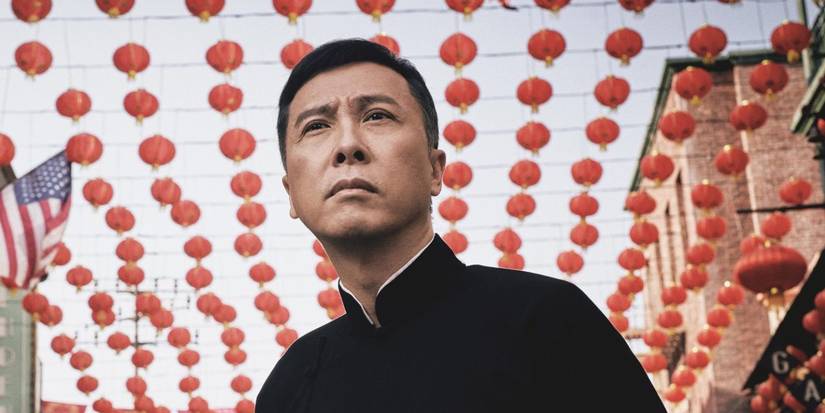 Donnie Yen standing under several rows of Chinese lanterns in Ip Man 4