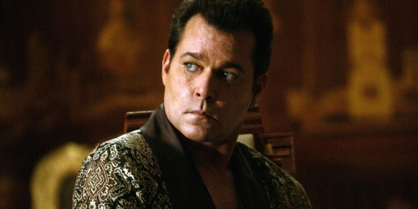 Dorothy Macha (Ray Liotta) sits in a fancy robe looking over his shoulder with a menacing scowl in 'Revolver' (2005)