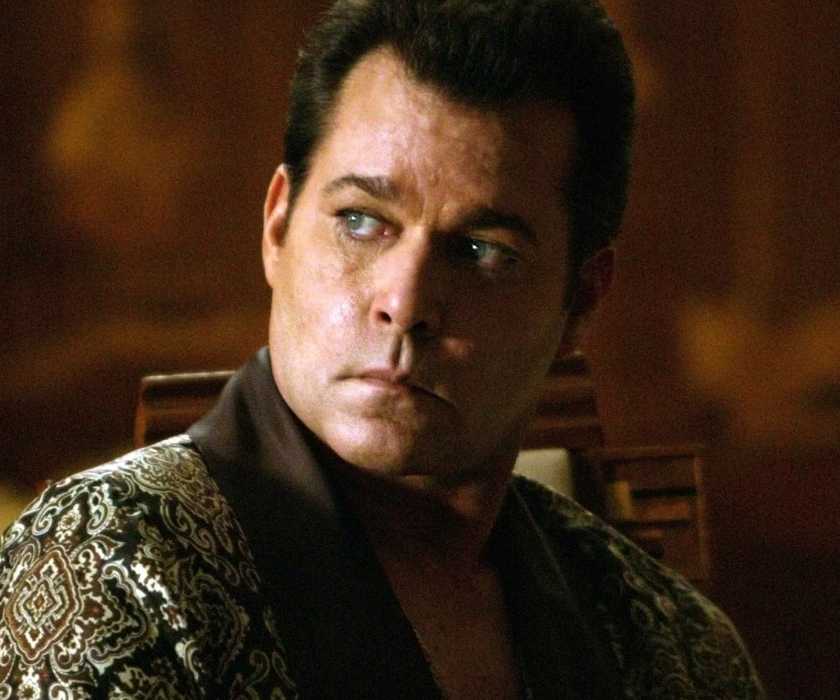 Dorothy Macha (Ray Liotta) sits in a fancy robe looking over his shoulder with a menacing scowl in 'Revolver' (2005)