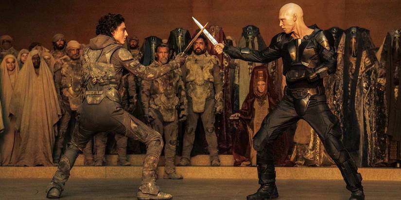 Paul Atreides and Feyd-Rautha face off with knives while a crowd watches on in 'Dune: Part Two'