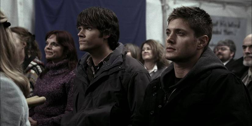Sam and Dean Winchester sit in a congregation of a faith healer.