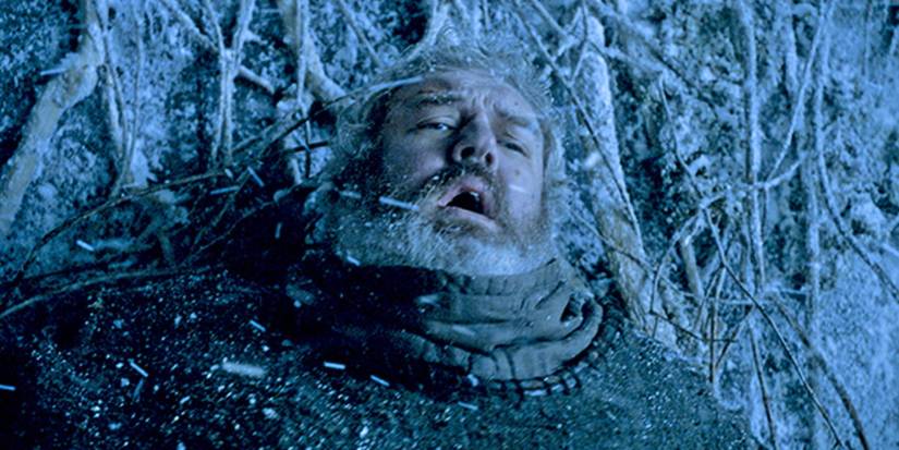 Hodor (Kristian Nairn) holding a door in the snow so his friends can escape the Wights in Game of Thrones.
