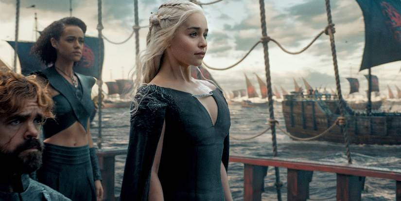 Daenerys stands tall on a ship with advisors as she and her armies set sail for Westeros.