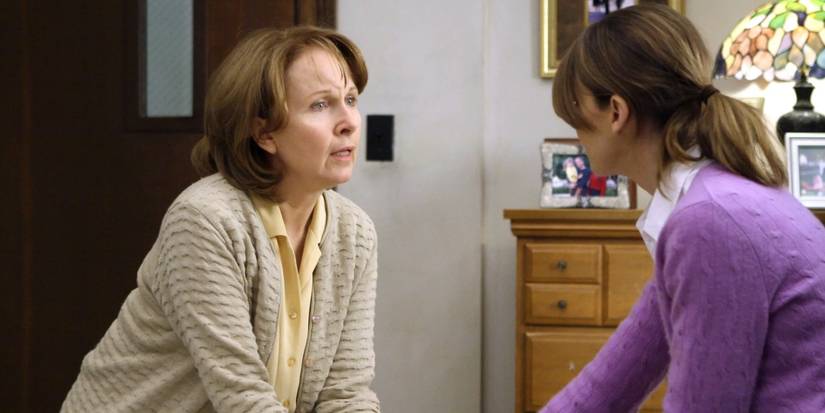 Ellis Grey (Kate Burton) looking stressed and clutching Meredith's (Ellen Pompeo) hand in Grey's Anatomy