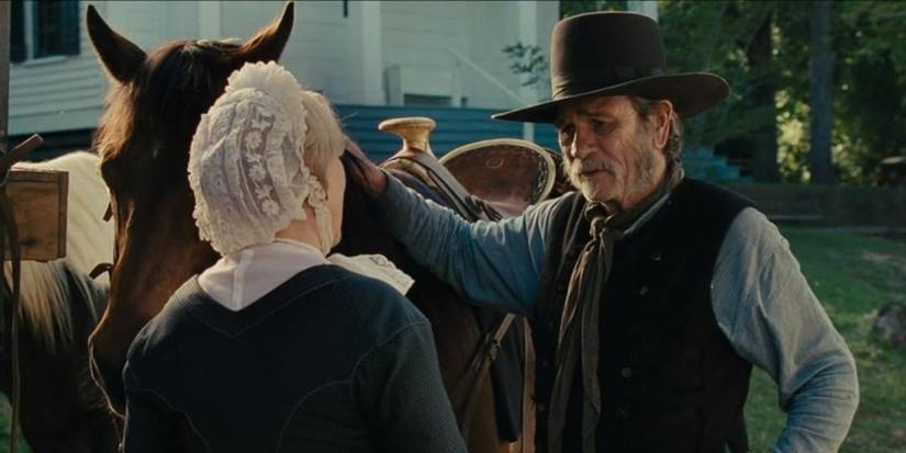 Tommy Lee Jones talking to Meryl Streep by his horse in The Homesman