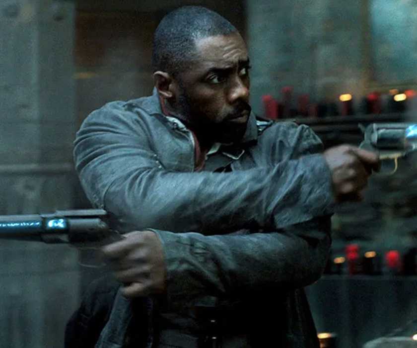 Idris Elba as Roland Deschain firing two gun in The Dark Tower