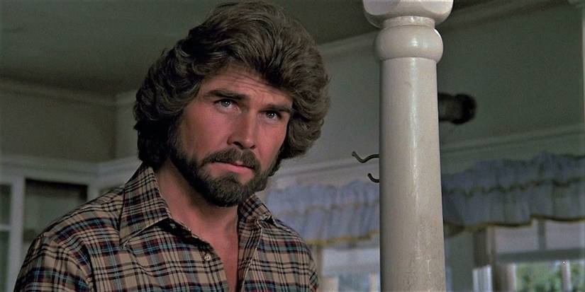 George Lutz looks at someone in the house in The Amityville Horror.