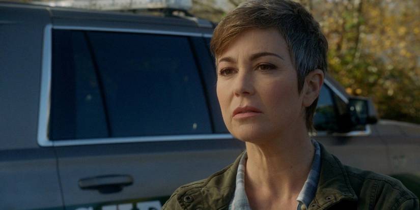 Jody Mills (Kim Rhodes) stands by a patrol car glaring at something off in the distance on Supernatural