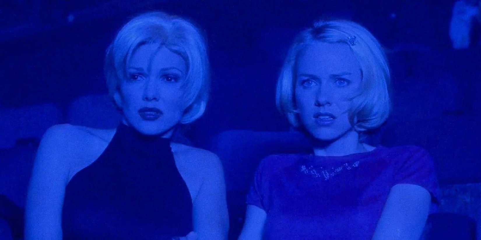 Rita and Betty in Mulholland Drive sit next to each other in a theater and look shocked.