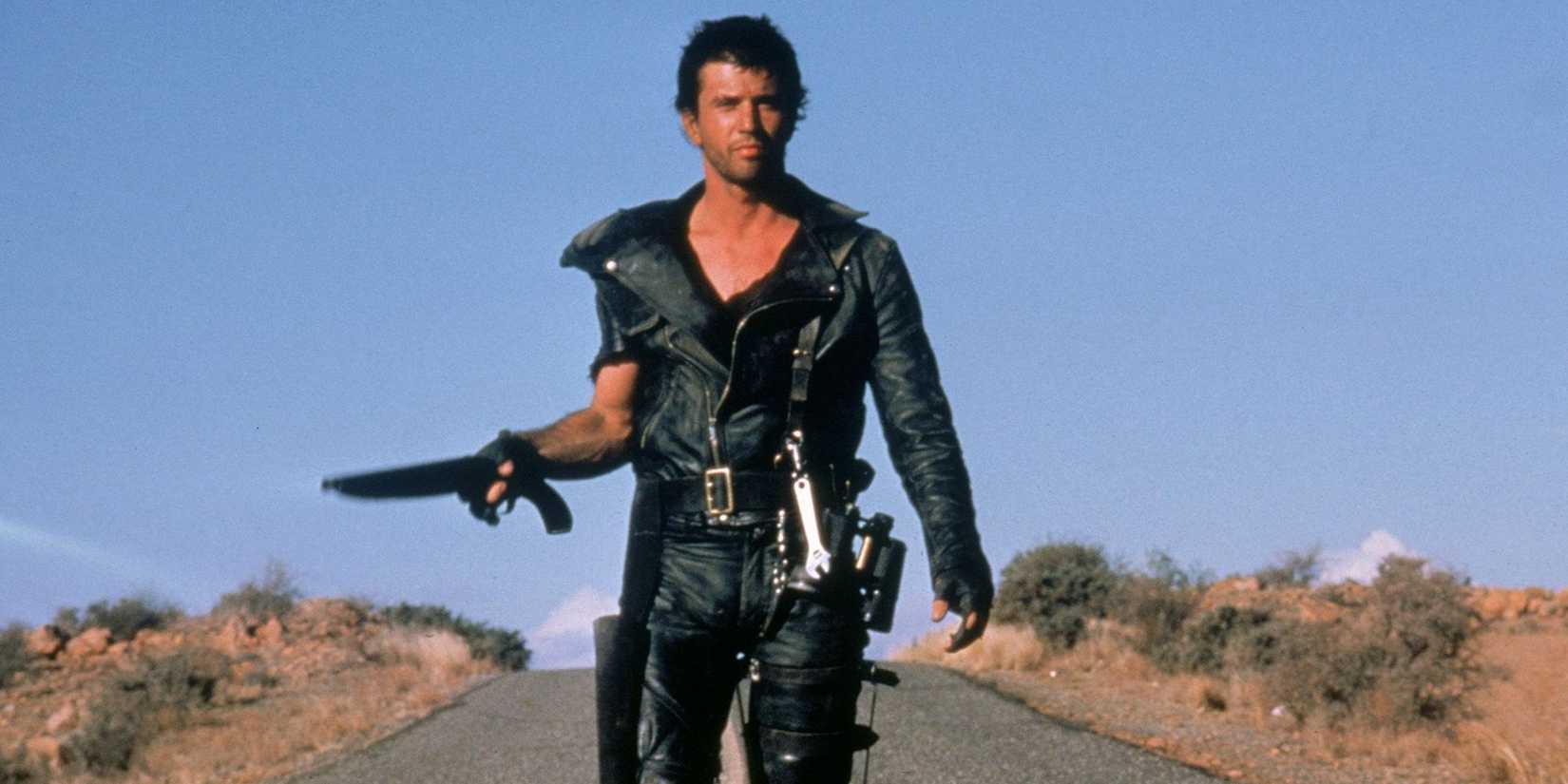 Mel Gibson walking down a lonely highway in Mad Max 2