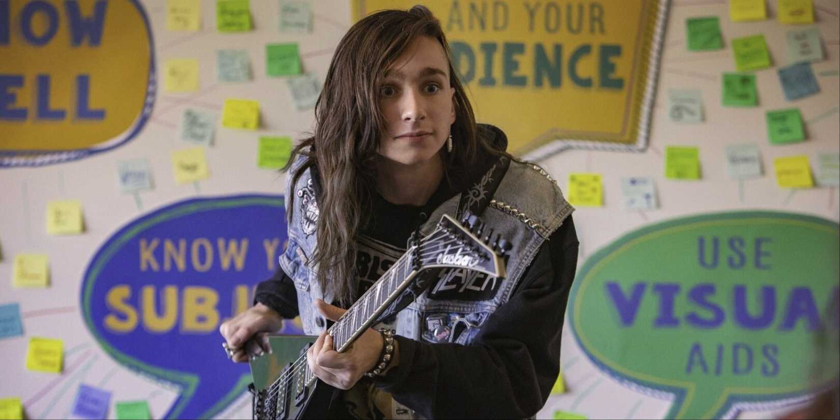 A still from the film Metal Lords featuring a long-haired teen with an electric guitar