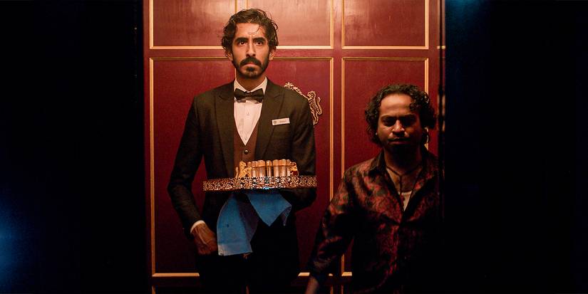 Dev Patel holding a tray in an elevator in Monkey Man