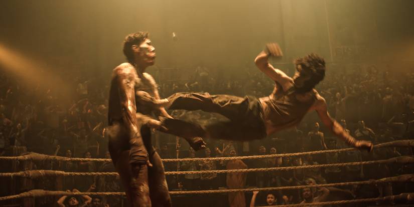 Dev Patel kicking a man in the chest with both feet in Monkey Man