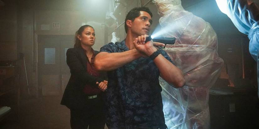 Two people searching a butcher's shop with flashlights in NCIS: Hawaii Season 1, Episode 13.