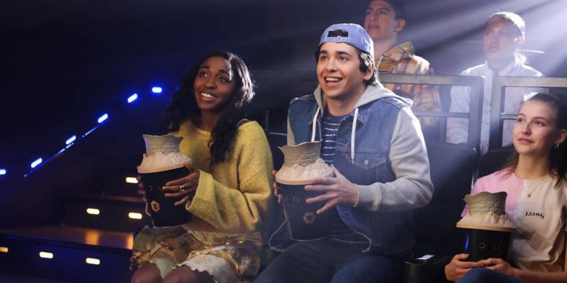 Ayo Edebiri and Marcello Hernández sitting in a movie theater holding Dune 2 popcorn buckets in a Saturday Night Live skit.