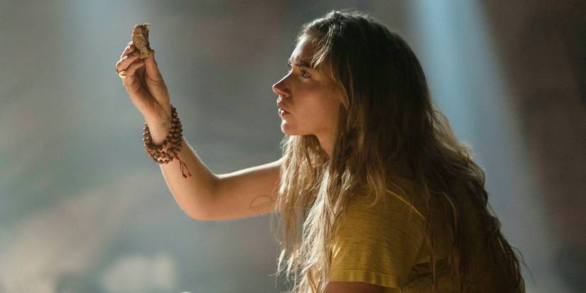 Imogen Poots holding up and looking at a small object in Outer Range.