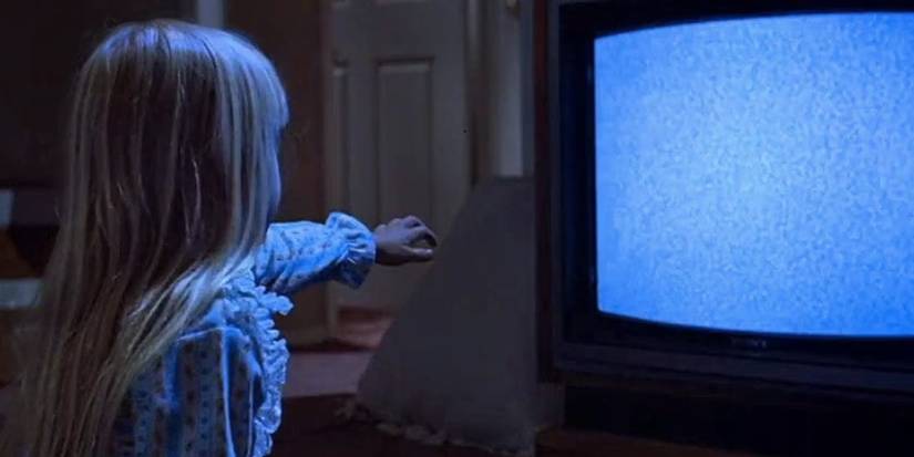 Carol Anne Freeling (Heather O'Rourke) reaching out to the TV in 'Poltergeist'