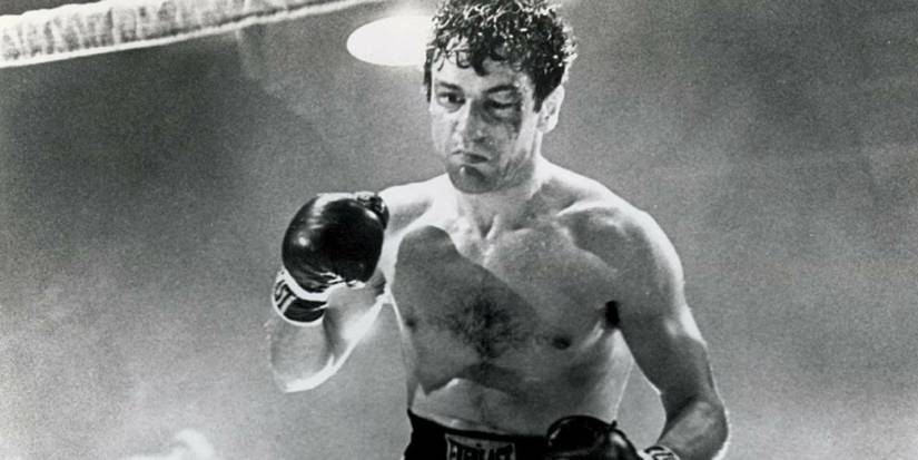 Robert De Niro as Jake LaMotta with a heavily bruised face fighting in the ring in Raging Bull.