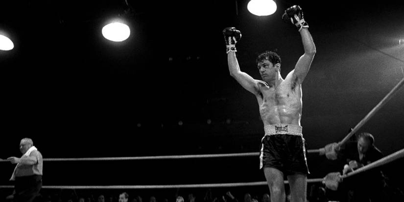 Jake LaMotta raising his fists in the air in the ring in Raging Bull