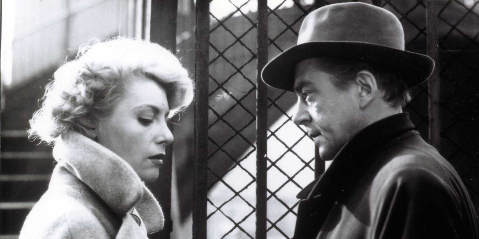 Marie Sabouret as Mado and Jean Servais as Tony "le Stéphanois" standing together in Rififi