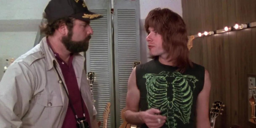 Marty Di Bergi talking to a young man in This Is Spinal Tap