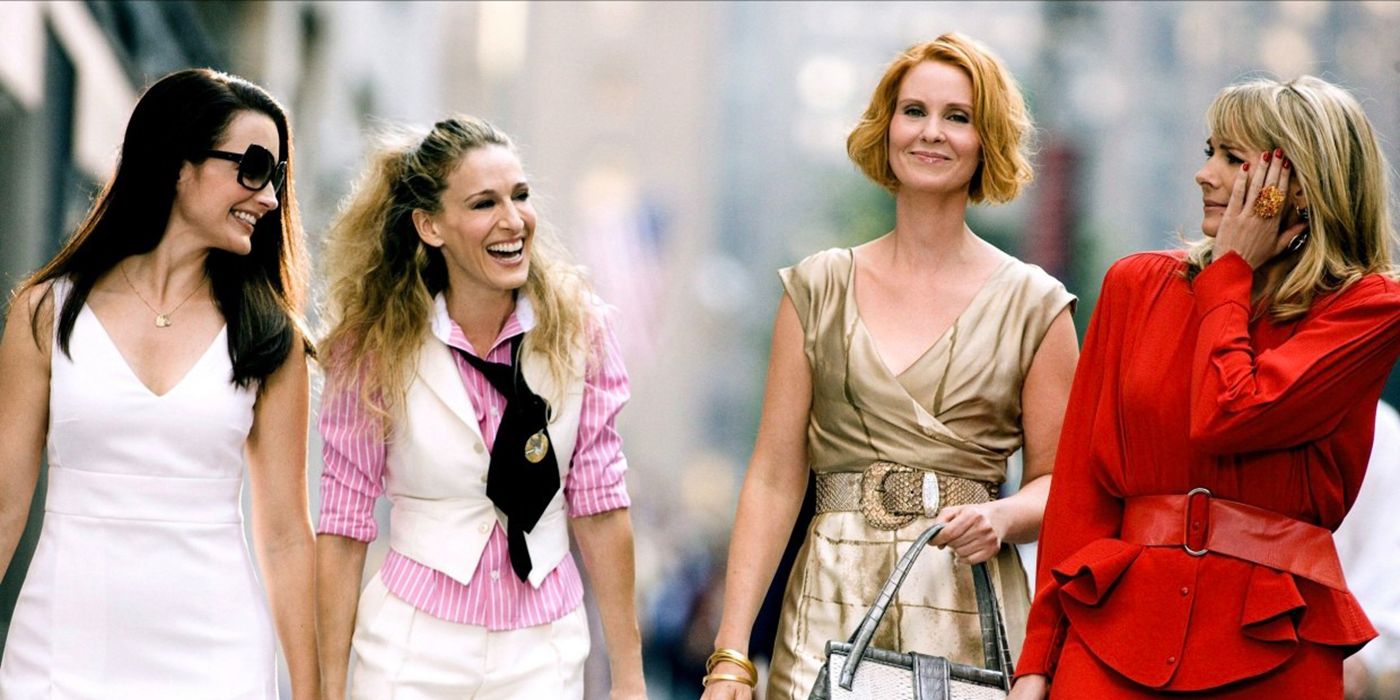 Charlotte, Carrie, Miranda, and Samantha walking down the street smiling and laughing in Sex and the City.