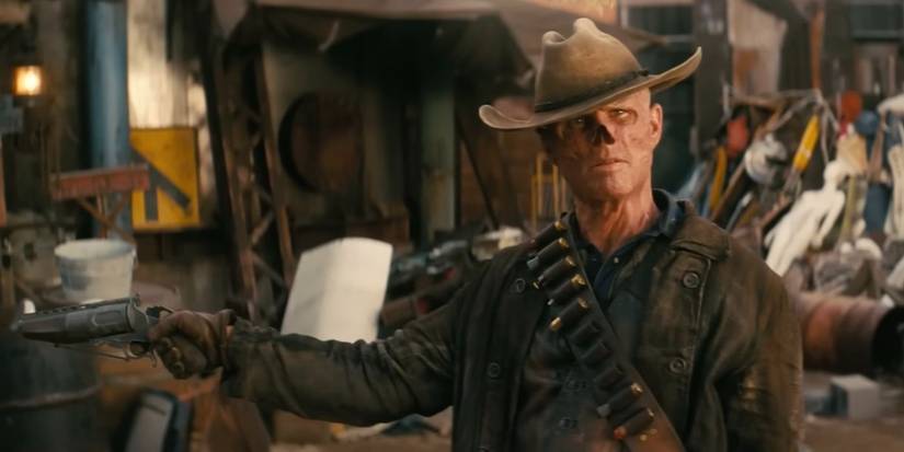 Walton Goggins as The Ghoul holds his arms wide with a gun loose in one hand in Prime Video's 'Fallout'