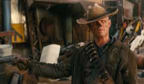 Walton Goggins as The Ghoul holds his arms wide with a gun loose in one hand in Prime Video's 'Fallout'