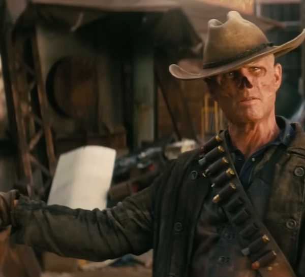 Walton Goggins as The Ghoul holds his arms wide with a gun loose in one hand in Prime Video's 'Fallout'