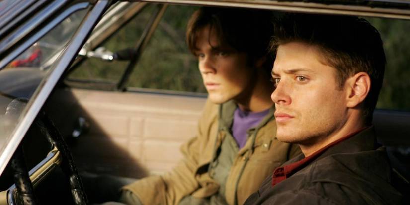 Jared Padalecki and Jensen Ackles as Sam and Dean sitting in the Impala in the Supernatural pilot episode.