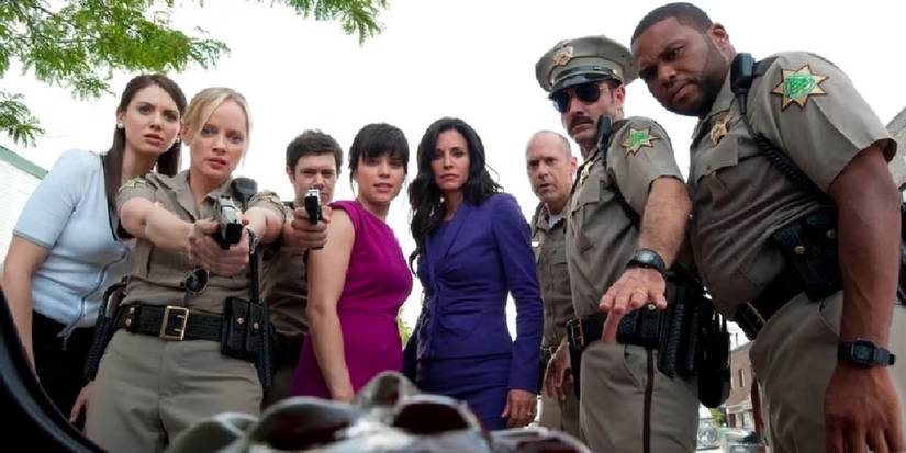 The cast of 'Scream 4' stand over a dead body in Scream 4.