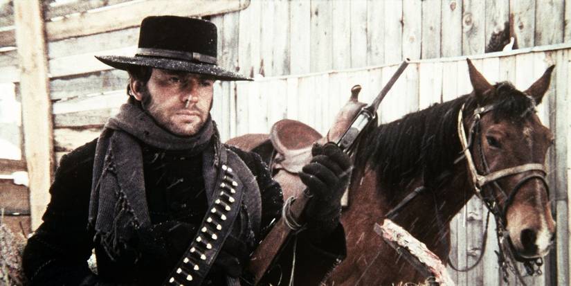 Jean-Louis Trintignant standing next to a horse in The Great Silence