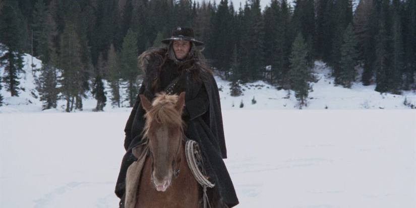 Jean-Louis Trintignant riding a horse through the snow in The Great Silence