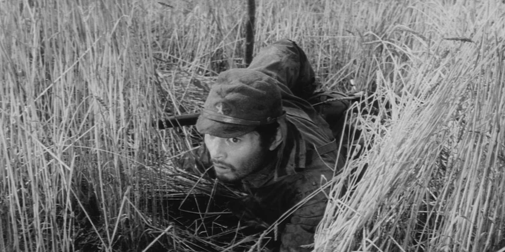 A soldier in a wheat field in The Human Condition III - A Soldier's Prayer - 1961