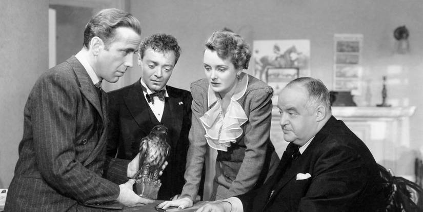 Brigid O'Shaughnessy, Sam Spade, and others huddle around the Falcon statue in The Maltese Falcon