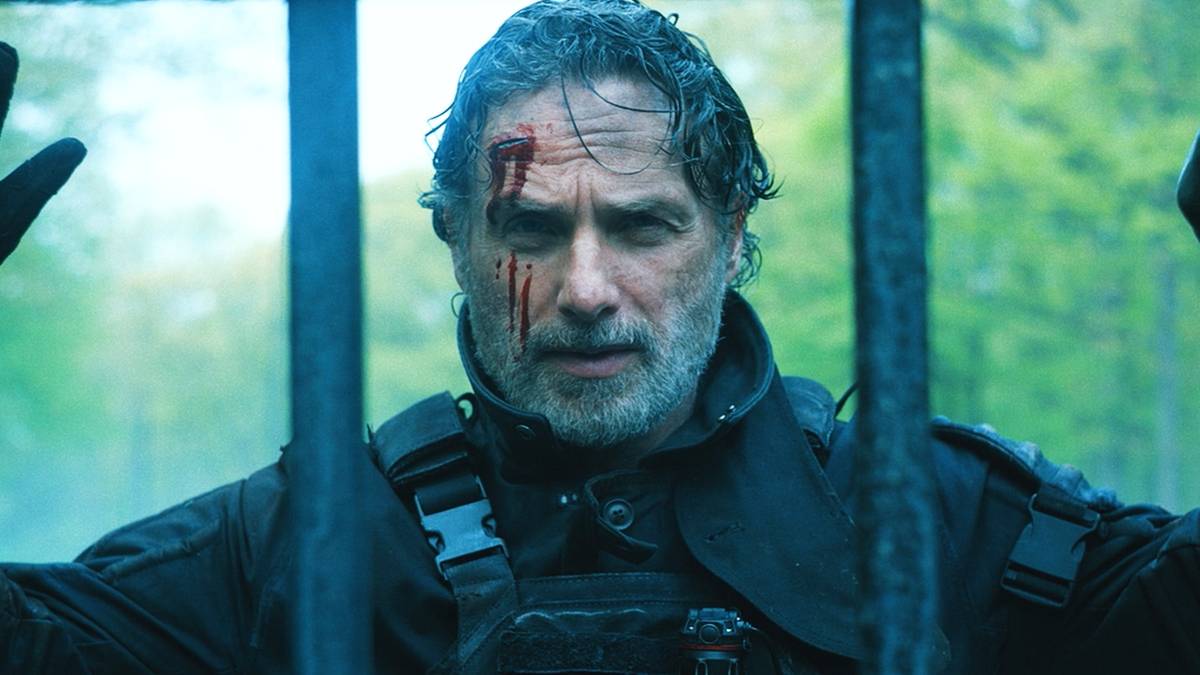 Andrew Lincoln as Rick Grimes with his hands up in The Walking Dead: The Ones Who Live
