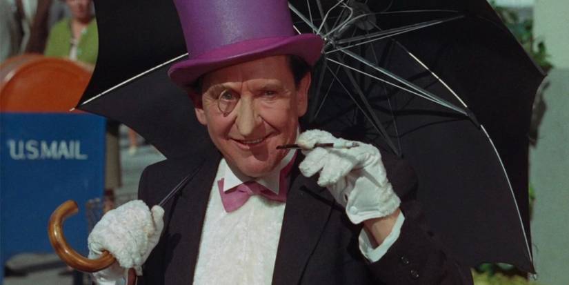 The Penguin from 'Batman' holding an umbrella, smoking, and smiling