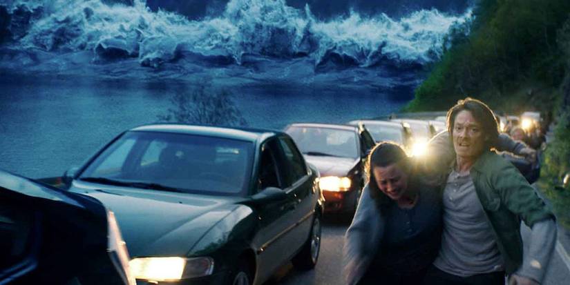 the wave approaches a highway as a couple run for safety
