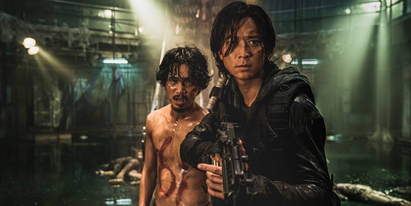 Gang Dong-won as Jung-seok protecting a man from a zombie horde in 'Train to Busan Presents: Peninsula'