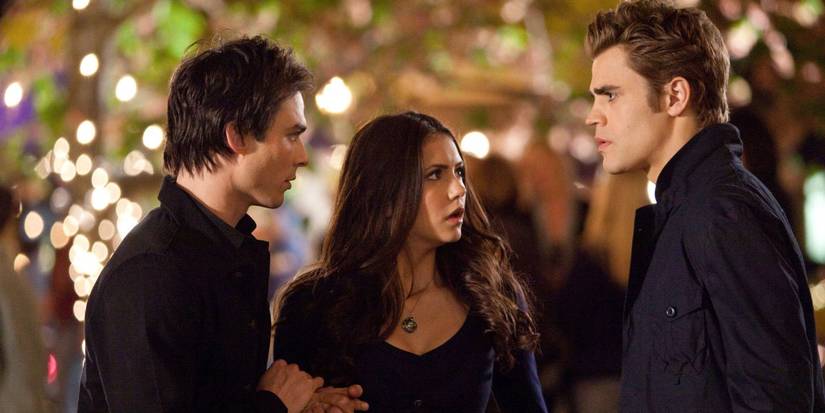 Damon (Ian Somerhalder) and Elena (Nina Dobrev) look at Stefan (Paul Wesley) in The Vampire Diaries.