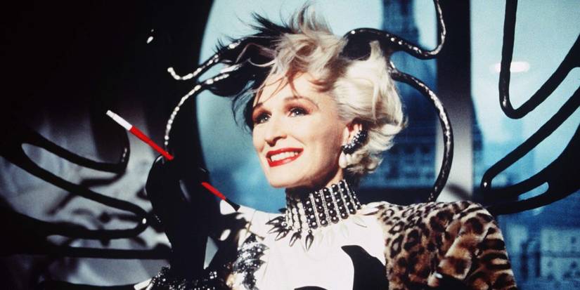 Glenn Close as Cruella de Vil smiling while holding her cigarette in 101 Dalmatians.