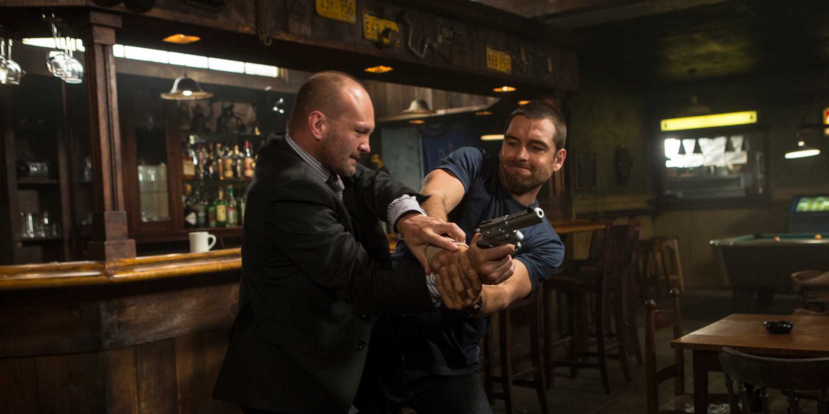 Two men struggle over a gun in Banshee.