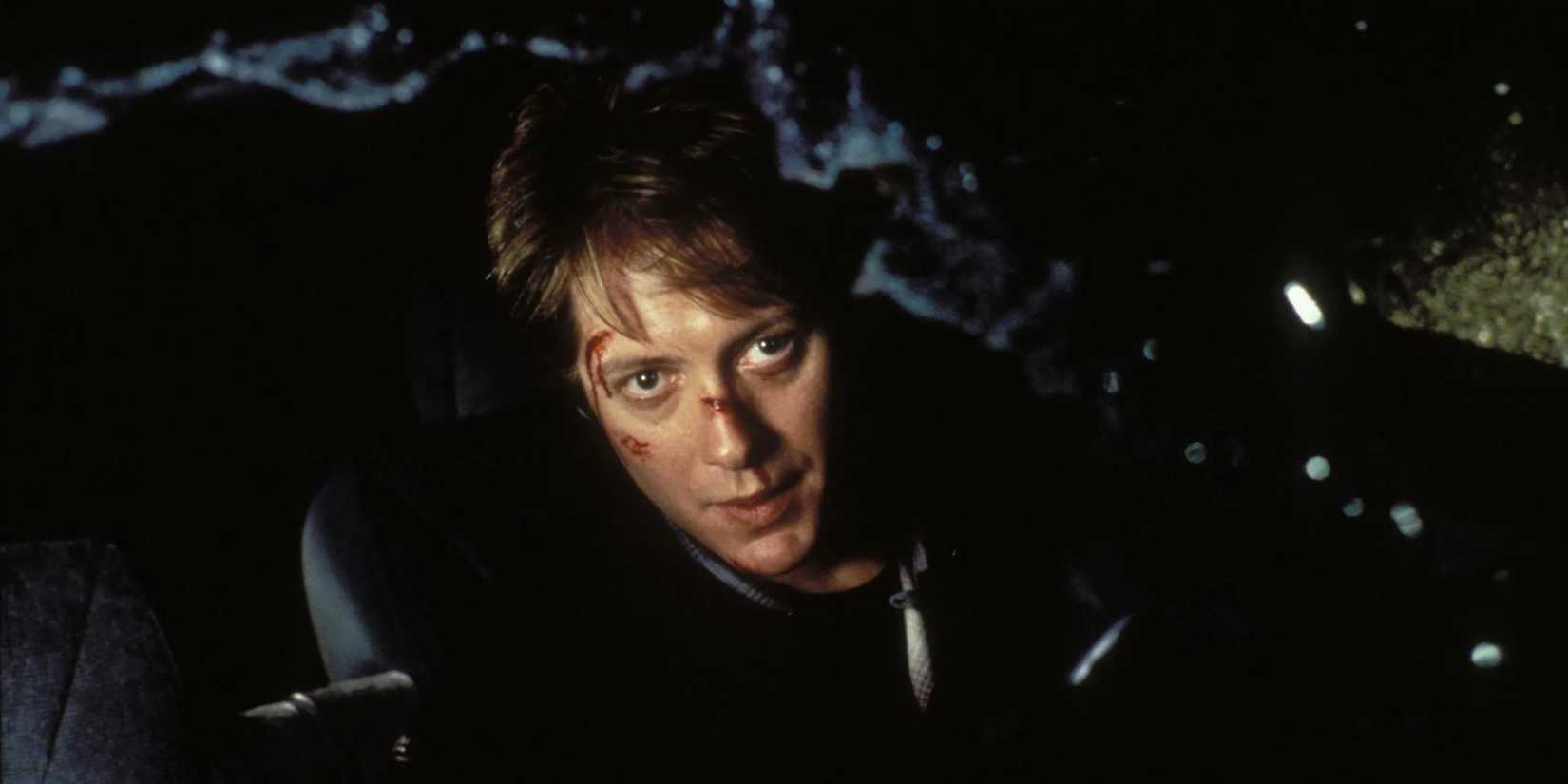 James Spader with cuts in his face looking out a broken windshield in Crash