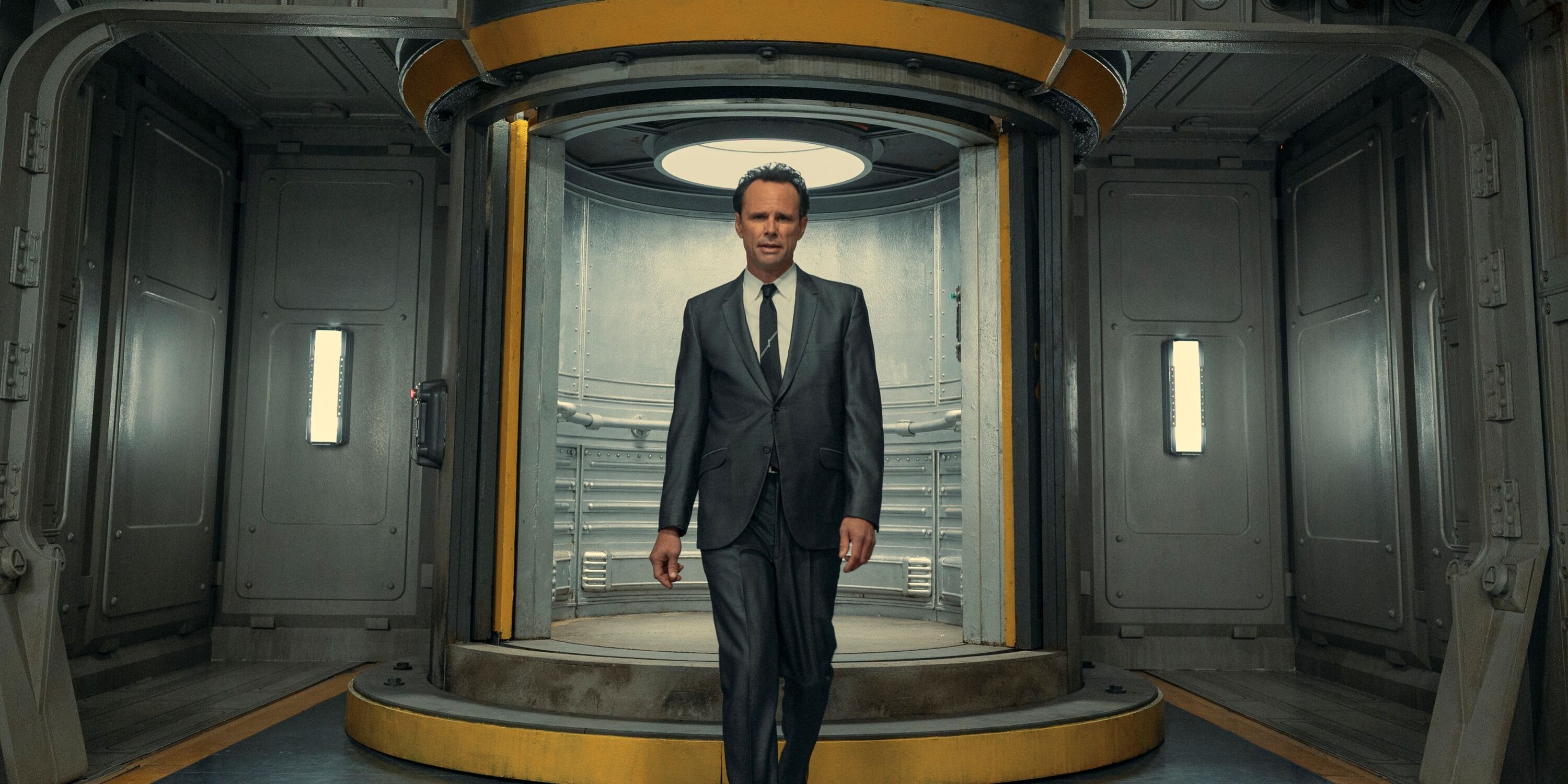 Walton Goggins as Cooper Howard walking down a vault hallway in Prime Video's Fallout