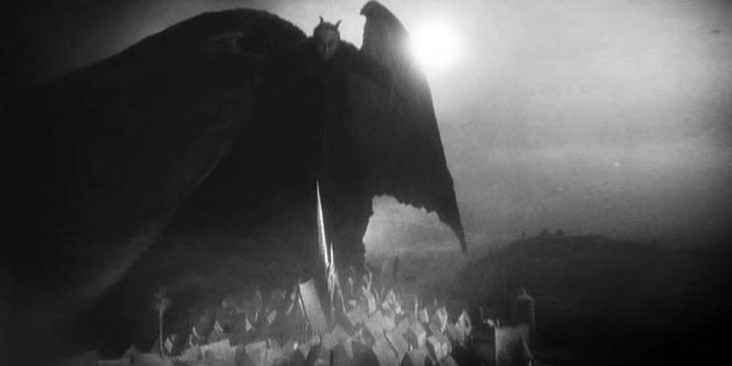 A winged figure standing atop a hill in Faust - 1926