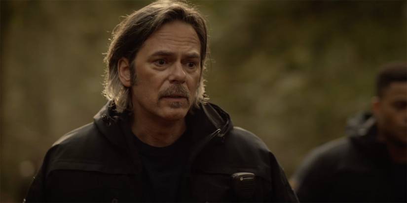 Vince Leone (Billy Burke) stands outside and looks worried on a call in 'Fire Country.'