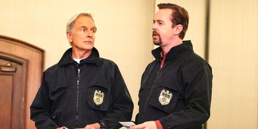 Gibbs and McGee sharing a chat with someone offscreen while Gibbs observes McGee on NCIS