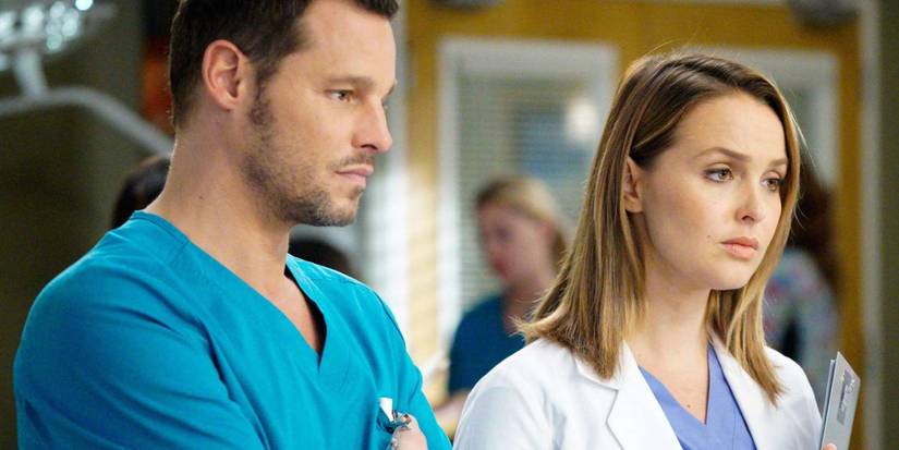 Jo Wilson and Alex Karev look ahead in the hospital with somber expression in Grey's Anatomy.