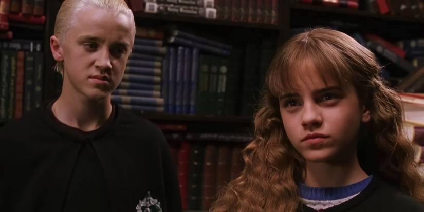 Draco (Tom Felton) glares at Hermione (Emma Watson) in Harry Potter and the Chamber of Secrets